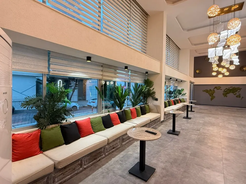 Ayseli Hotel lobisinde bitkiler ve gün ışığı alan oturma alanı
